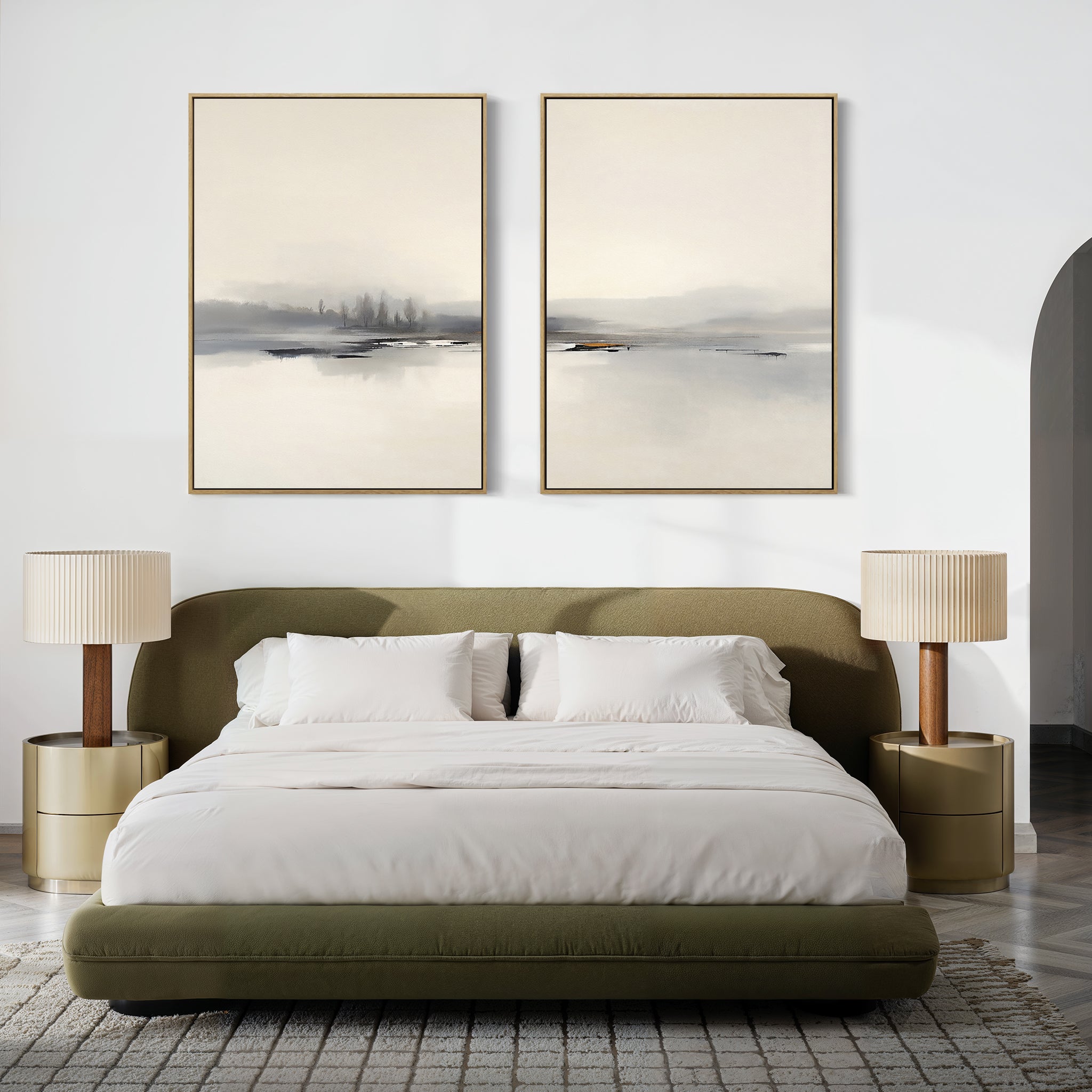 A modern bedroom with an olive green bed, white bedding, two beige nightstands and matching lamps, plus the "Peaceful Lake Morning - Set Of 2" serene landscape prints above the bed. Minimalist decor and neutral tones create a peaceful atmosphere.