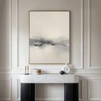 A minimalist room features the Peaceful Lake Morning Canvas Art - Vertical above a modern console table, decorated with candles, a white sculpture, and a small wooden container for a peaceful atmosphere.