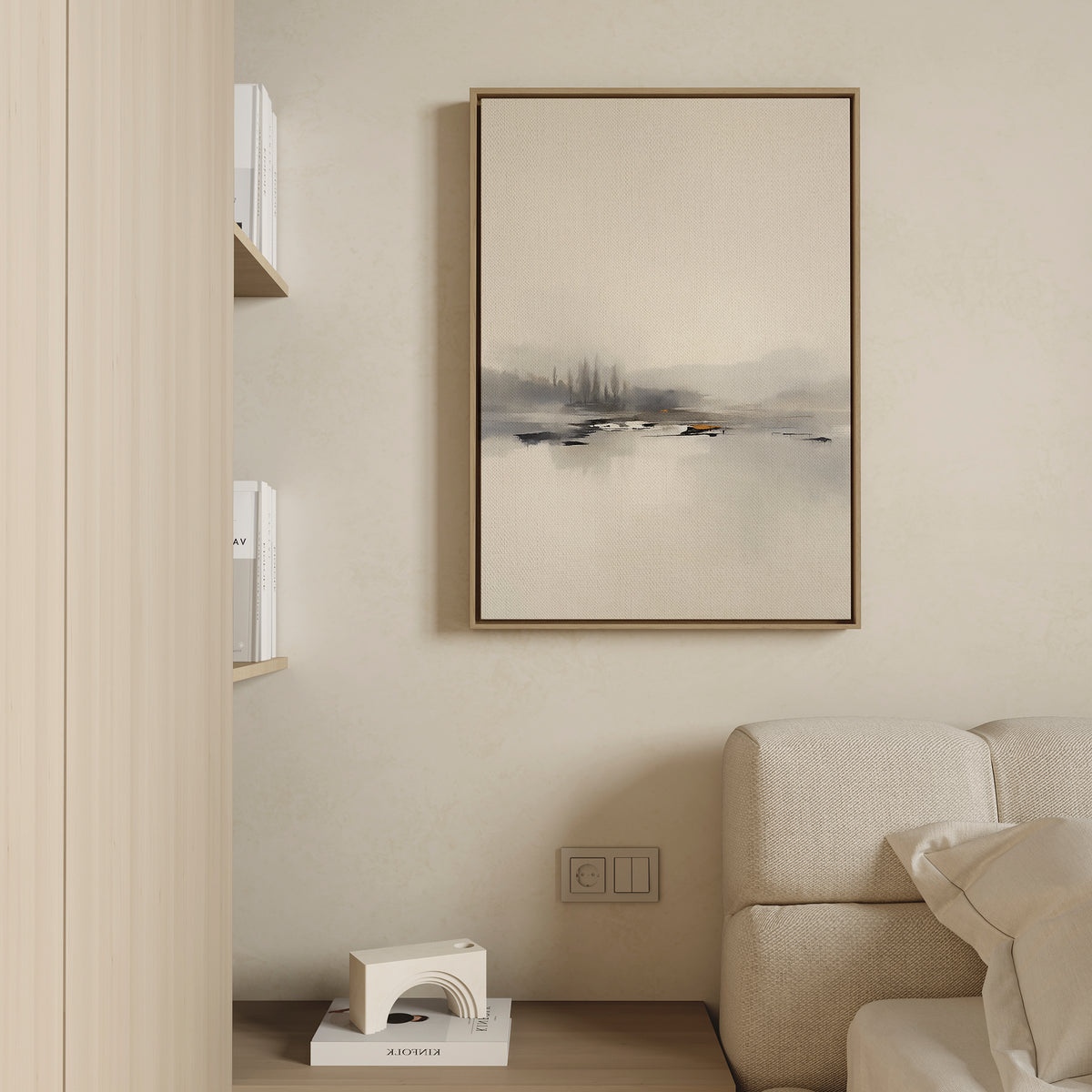 A minimalist living room with a beige sofa, built-in bookshelves, a modern white decor piece, and the Peaceful Lake Morning Canvas Art - Vertical adds a tranquil touch to the wall.