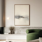 A modern living room features the Peaceful Lake Morning Canvas Art - Vertical, a green curved sofa, a marble accent wall, and dried flowers on a low shelf, creating a tranquil atmosphere.