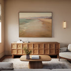 A modern living room features a light gray sofa, wooden coffee table, textured wood sideboard, neutral rug, and the Pier Dreams Canvas Art - Horizontal above the sideboard. A wall sconce and window offer soft lighting.