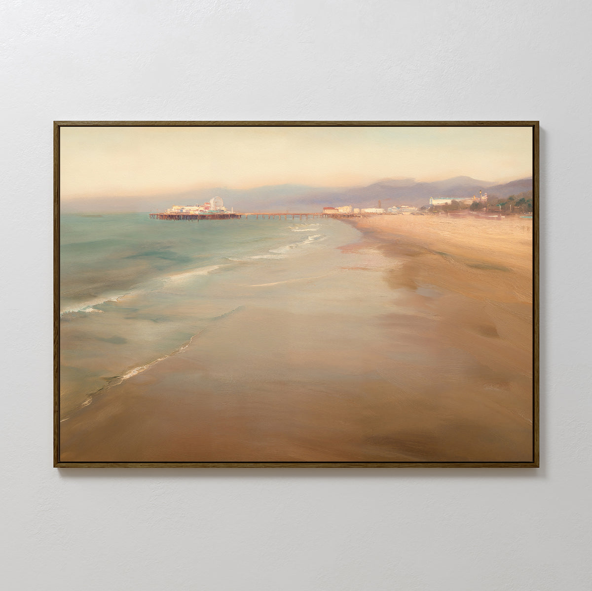 The Pier Dreams Canvas Art - Horizontal features a framed coastal scene with gentle waves, sandy shore, a distant pier, and soft mountains in warm tones—perfect as dreamy wall art for a plain light-colored wall.