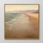 Bring serene Nordic Park vibes to your space with the "Pier Dreams Canvas Art - Square," featuring a sandy beach, gentle waves, a pier stretching into calm sea, and distant mountains beneath a hazy sky—perfect dreamy wall décor.
