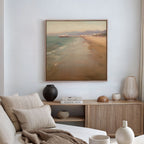 A neutral-toned living room features a cozy sofa with cushions, a wooden sideboard displaying vases and books, and the Pier Dreams Canvas Art - Square—a coastal beach scene—hanging as dreamy wall art above.