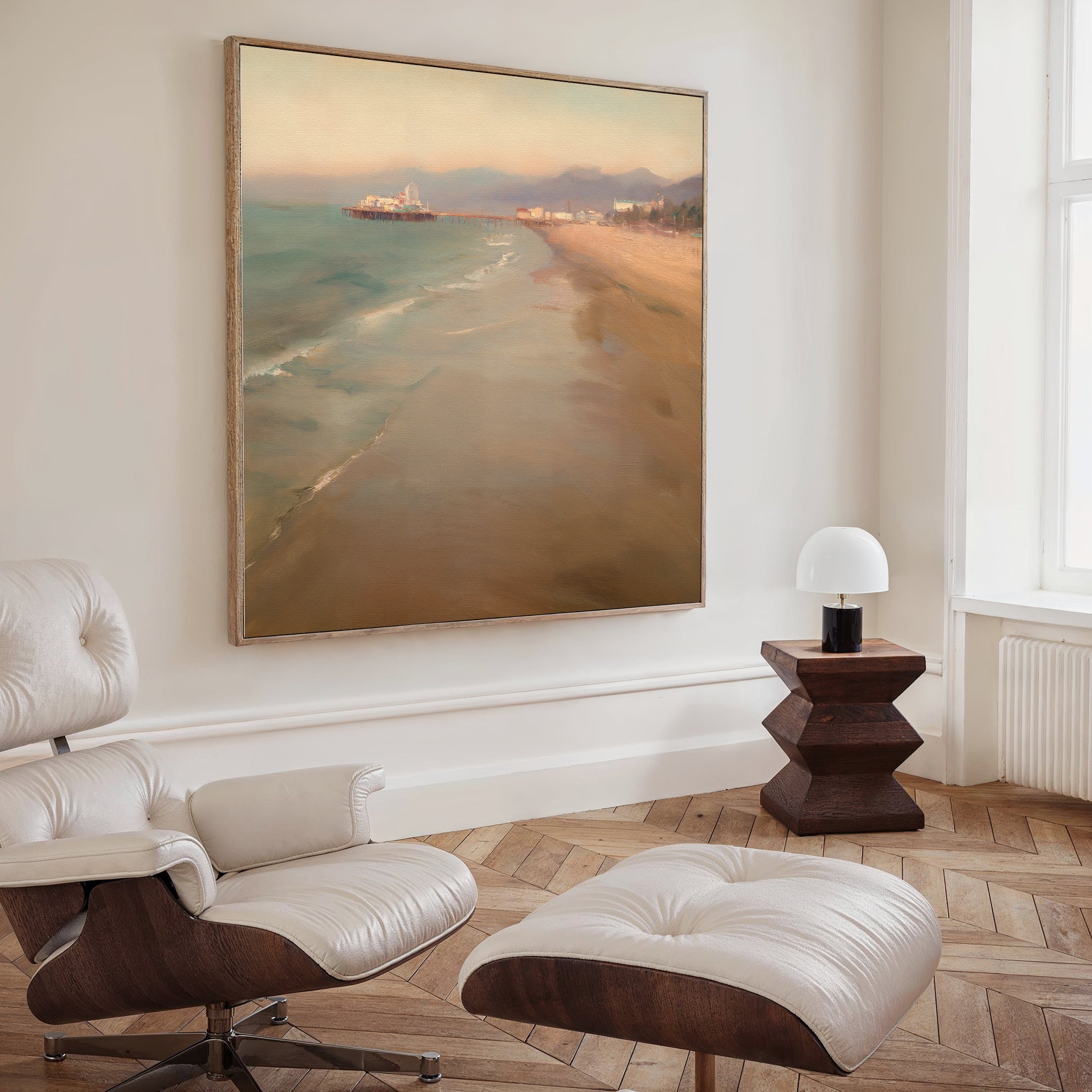 A modern living room with a white leather lounge chair and ottoman, a small wooden side table with a white lamp, and the Pier Dreams Canvas Art - Square as dreamy beach-themed wall decor.
