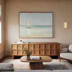 A cozy living room features a wooden sideboard, round coffee table, beige sofa, and the Freedoms Call Canvas Art above the sideboard, adding a coastal touch to the tranquil decor.