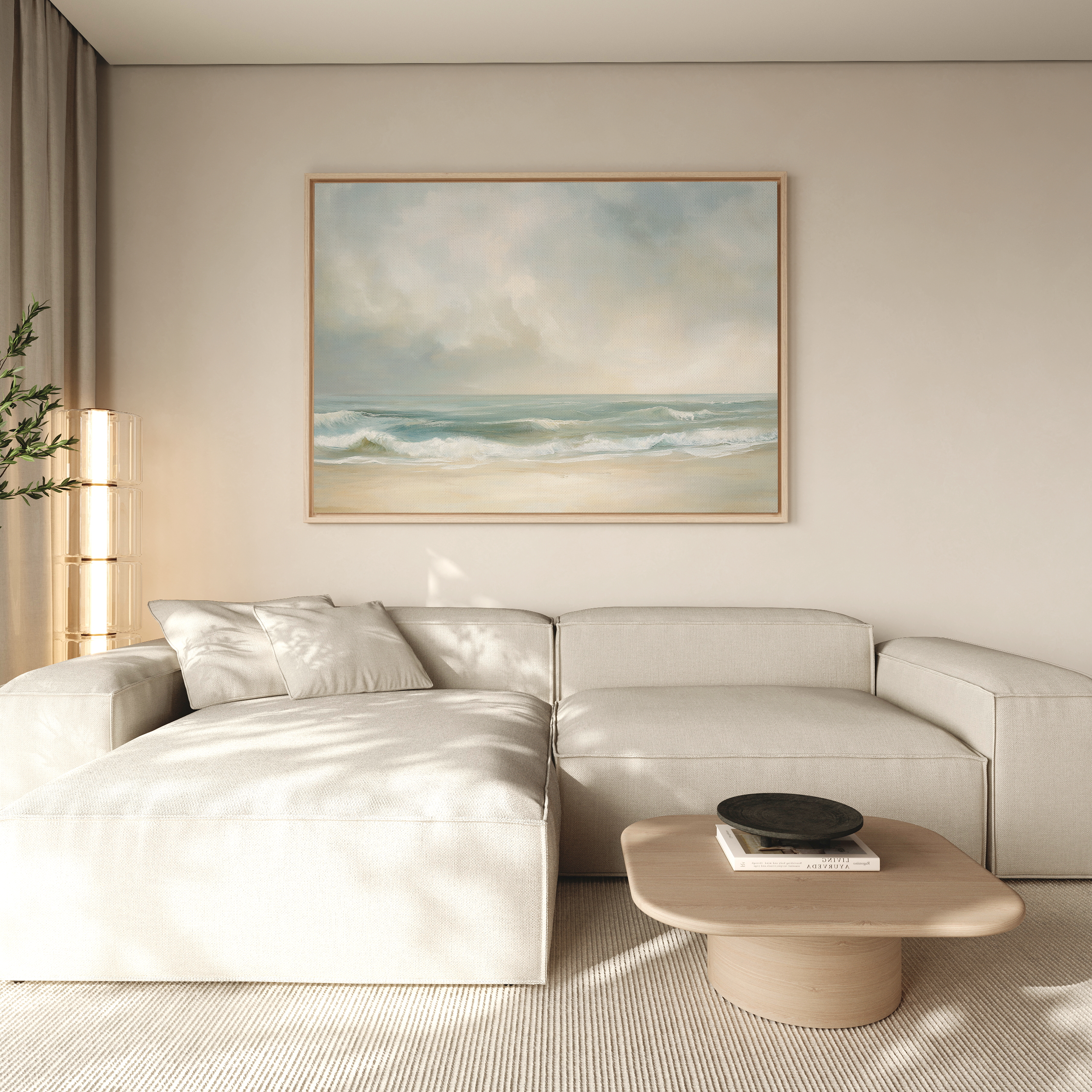 A modern living room features a light beige sectional sofa, a wooden coffee table with books and a bowl, and the Serene Beach Canvas Art hanging above the sofa, bringing a touch of tranquility.