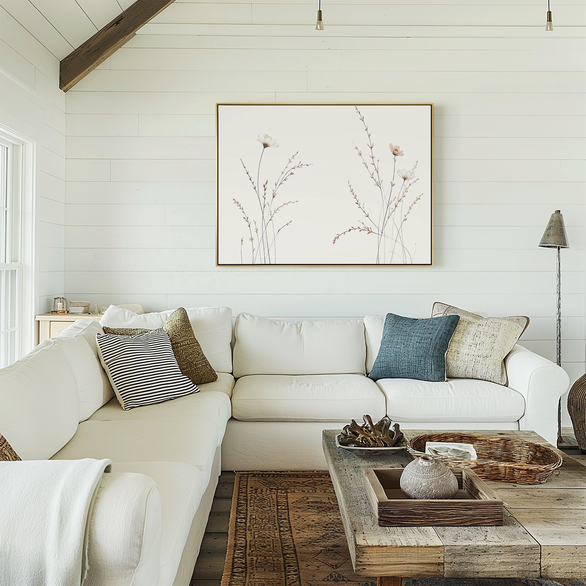 Bright, cozy living room with a white sectional sofa, assorted pillows, wooden coffee table, and the Prairie Whispers Canvas Art - Horizontal on white shiplap walls. Neutral tones and natural textures create a relaxing, inviting space.
