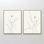 Prairie Whispers - Set of 2 features framed botanical wall art with delicate wildflowers and slender stems in soft, neutral tones, hung side by side—ideal for a Nordic Park-inspired space.