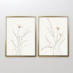 The Prairie Whispers - Set of 2 features minimalist framed art prints with hand-drawn wildflowers and grasses in neutral tones, offering timeless botanical wall art for your space.