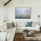 Brighten your space with the Purple Haze Canvas Art - Horizontal, paired with a cream sectional, neutral and blue pillows, rustic wood coffee table, and white shiplap walls—an elegant touch to elevate your living room decor.