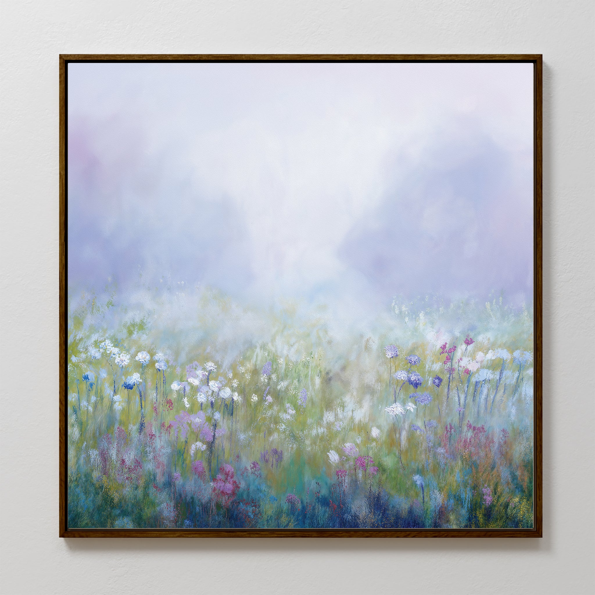 The Purple Haze Canvas Art - Square features a misty meadow with soft pastel tones and blooming wildflowers in white, purple, and pink—a dreamy, serene addition to your living room decor.
