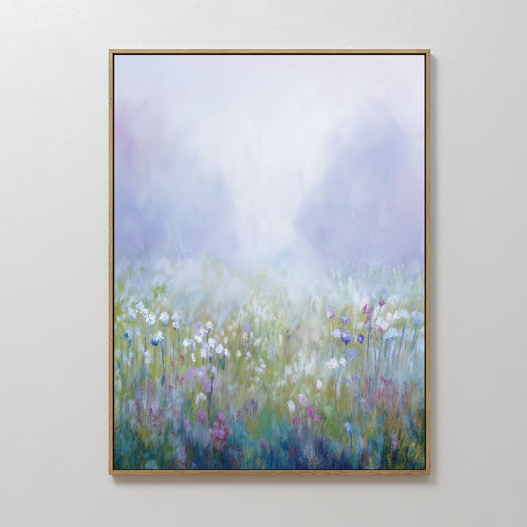 The Purple Haze Canvas Art - Vertical features a framed print of a misty meadow with white, pink, and purple wildflowers against a dreamy background—an ideal piece to add charm to your living room decor.