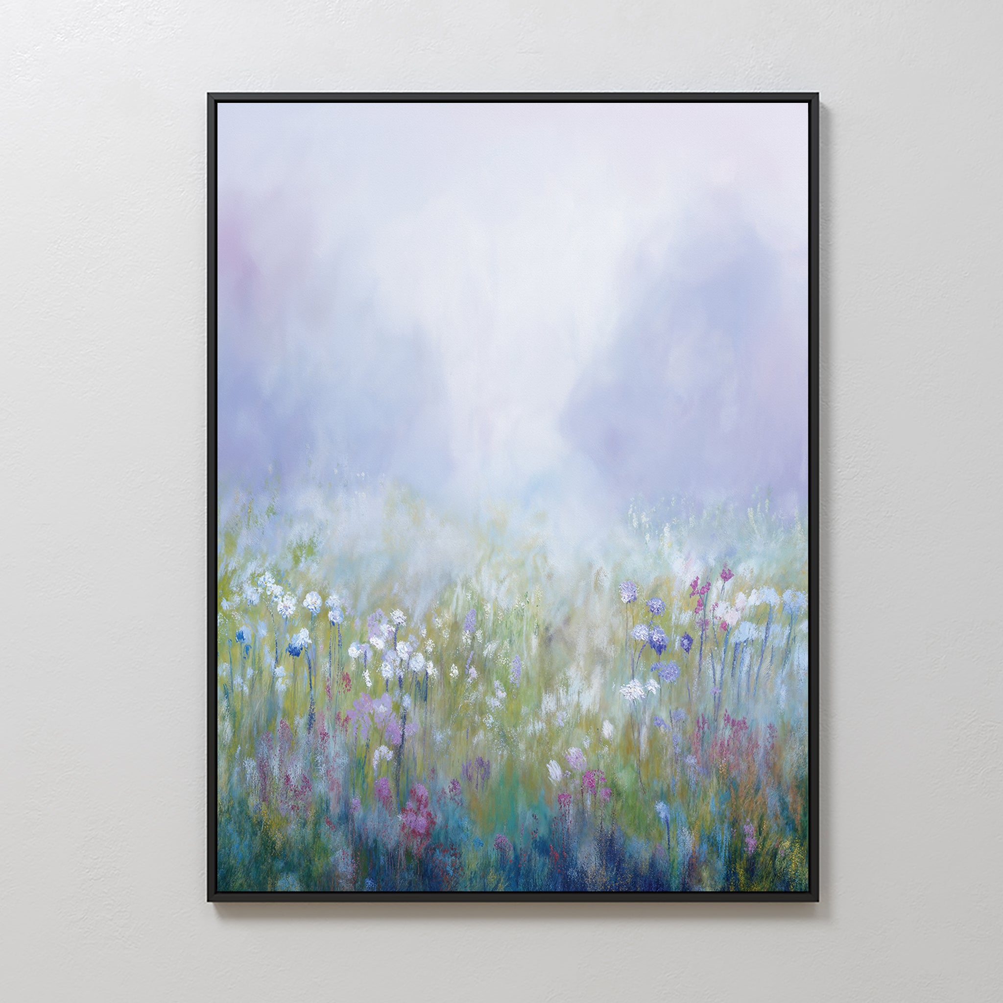 Purple Haze Canvas Art - Vertical: A framed canvas print depicting a misty wildflower field in soft pastels with delicate white, pink, and purple blossoms beneath a hazy sky—ideal for creating a calming bedroom ambiance.