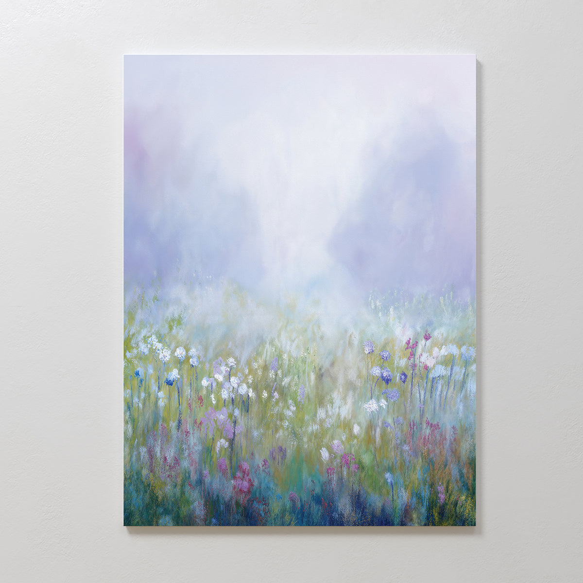 Purple Haze Canvas Art - Vertical features a dreamy wildflower field in soft pastel white, purple, pink, and blue tones with a misty backdrop—an ethereal canvas print that elevates any bedroom decor.