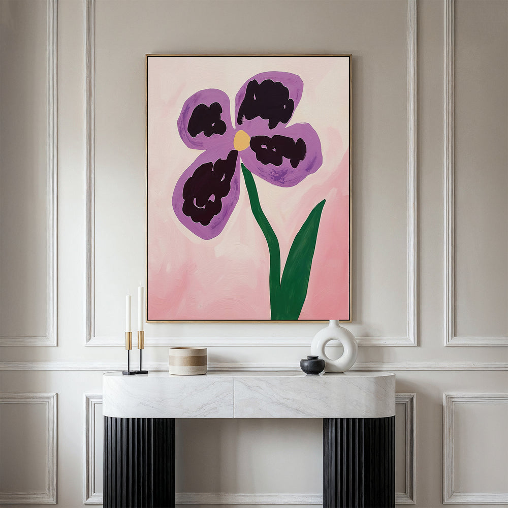 A minimalist room features a white marble console table, decorative objects, and the Purple Pansy Canvas Art - Vertical on a pink background, hanging on a paneled wall and evoking the serene spirit of Nordic Park.