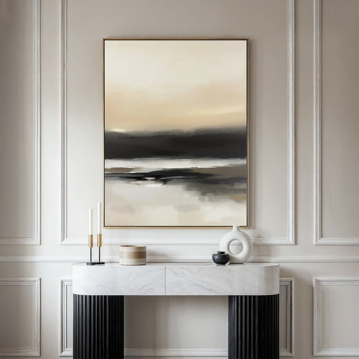 A modern console table with black legs and a white marble top stands against a beige paneled wall, adorned with decorative objects. Above it hangs the Quiet Shoreline Canvas Art - Vertical, adding a calm, minimalist touch in neutral tones.