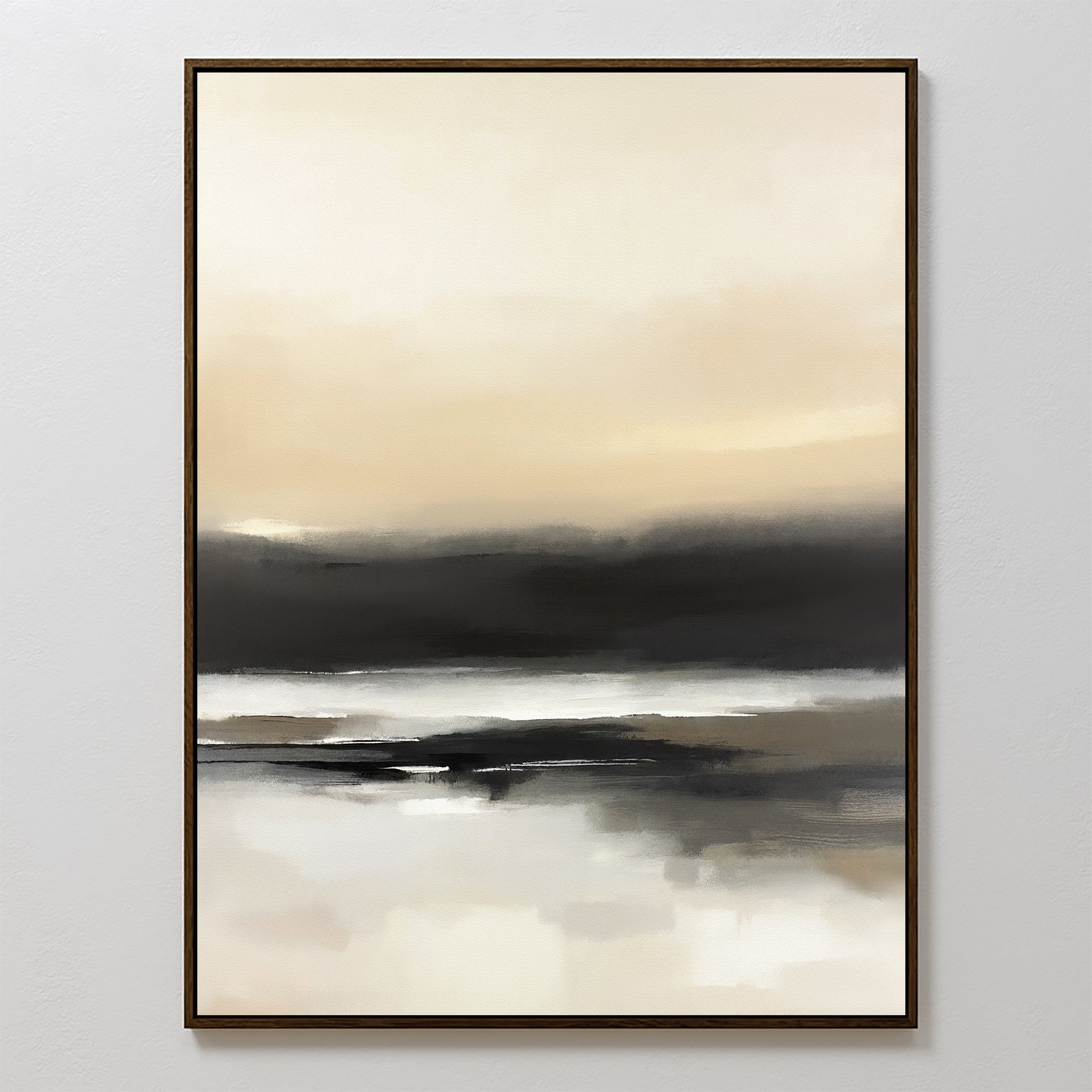 The Quiet Shoreline Canvas Art - Vertical features abstract coastal scenery in soft beige, cream, gray, and black tones. Minimalist and serene, it’s framed in dark wood and elegantly displayed on a white wall for a calming effect.