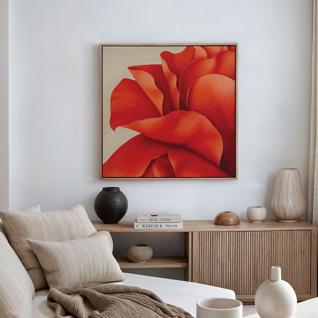 A modern living room featuring a beige couch, neutral cushions, wooden cabinet, ceramic vases, and the Red Elegance Abstract Canvas Art—a large piece with vibrant red and orange petals—adds a lively accent to the decor.