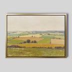 The Rolling Fields Canvas Art - Horizontal features a pastoral landscape with green and yellow fields, scattered trees, and distant hills under an overcast sky, shown against a light gray background.