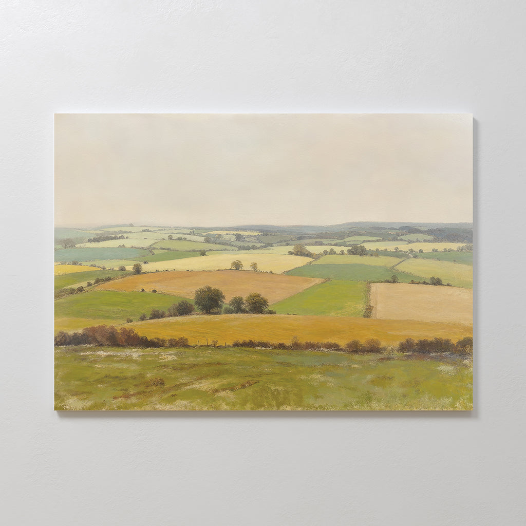 Bring tranquility to your space with the Rolling Fields Canvas Art - Horizontal, featuring a pastoral countryside landscape of green, yellow, and brown patchwork fields with trees and hedgerows under a soft, overcast sky.