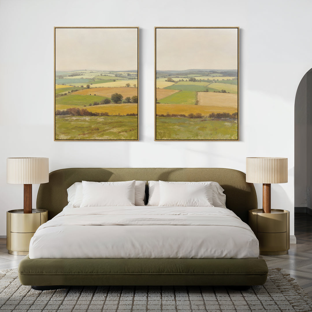 A modern bedroom features a green upholstered bed, white bedding, beige nightstands with matching lamps, and "Rolling Fields - Set of 2" wall art above the bed, showcasing tranquil pastoral countryside scenes in elegant frames.