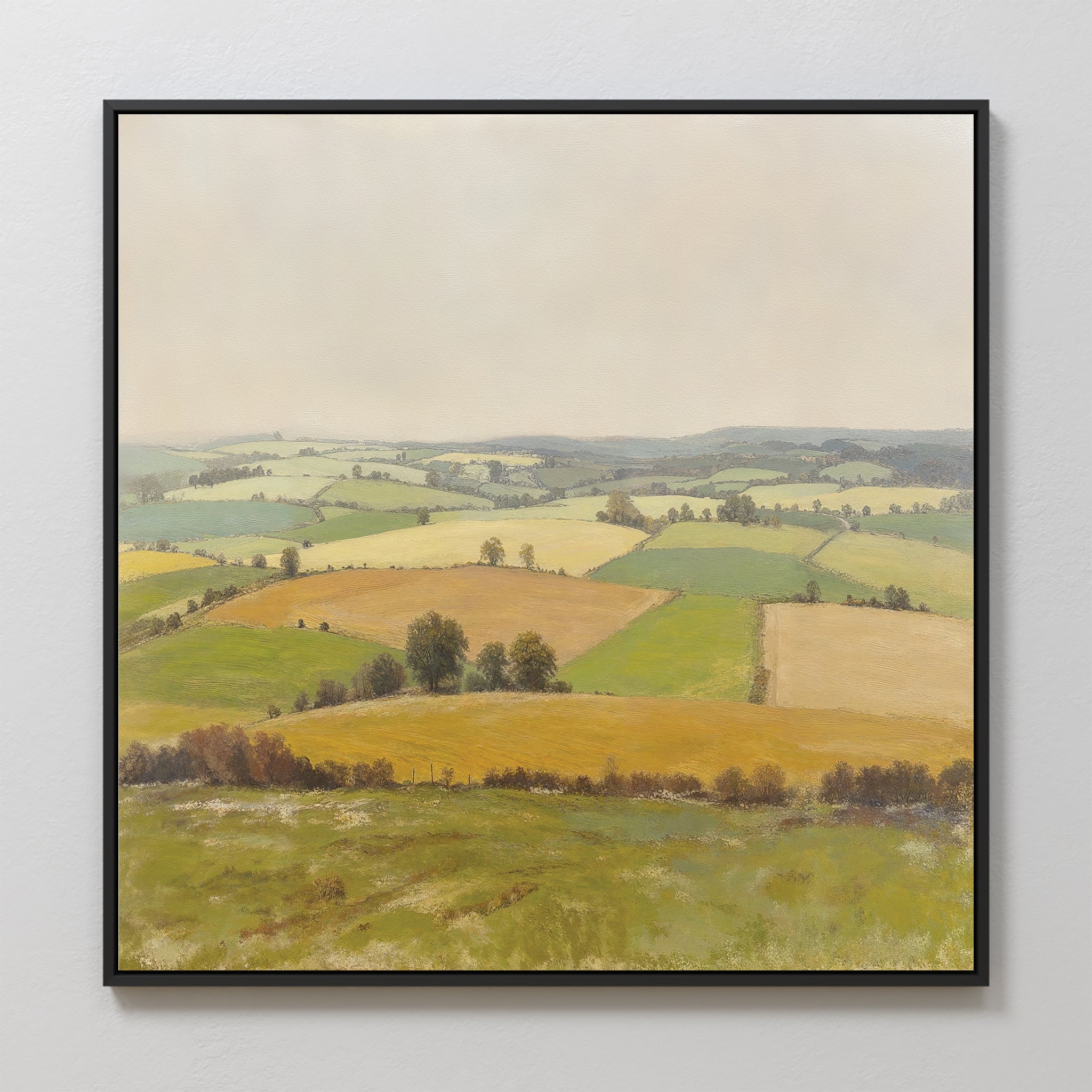 Rolling Fields Canvas Art - Square features a peaceful countryside landscape with rolling green, yellow, and brown fields and scattered trees beneath a pale sky—ideal as serene wall decor for any space.