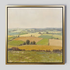The Rolling Fields Canvas Art - Square features a serene pastoral landscape of green and yellow fields with trees and hedgerows beneath a pale sky, beautifully framed for your home.