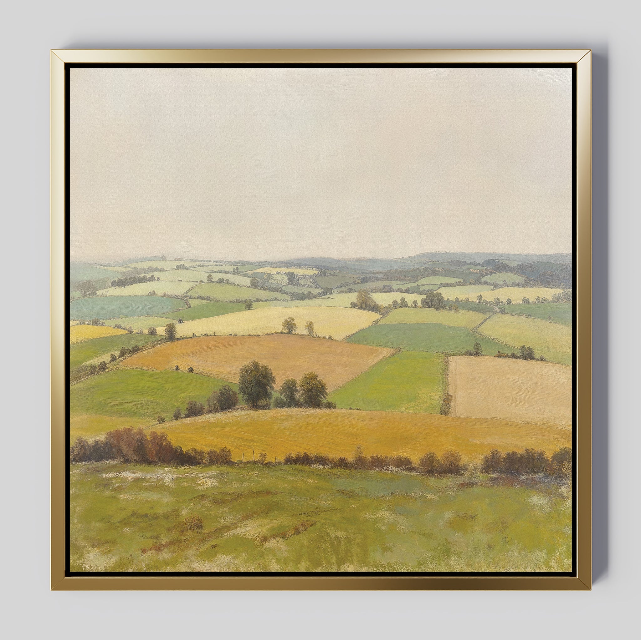 The Rolling Fields Canvas Art - Square features a serene pastoral landscape of green and yellow fields with trees and hedgerows beneath a pale sky, beautifully framed for your home.