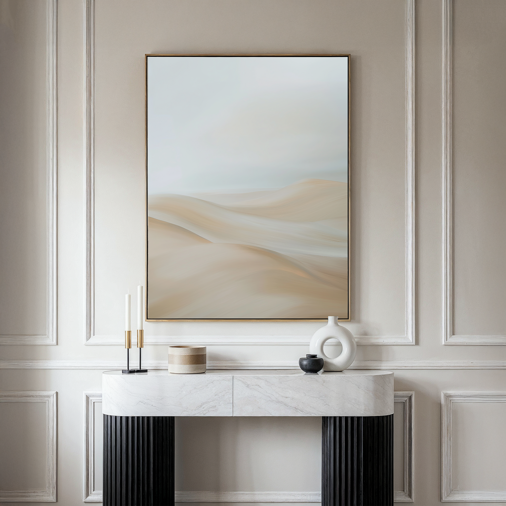 A minimalistic living room with a marble-topped console table, decorative vases, candles, and the Serene Peaks Abstract Canvas Art depicting soft beige sand dunes creates an inviting, contemporary ambiance.