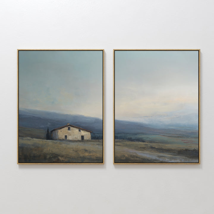 The "Rustic Solitude - Set of 2" features framed landscape wall art: one print depicts a rustic farmhouse in open fields with distant hills, while the other continues the serene décor with wide skies and rolling terrain.