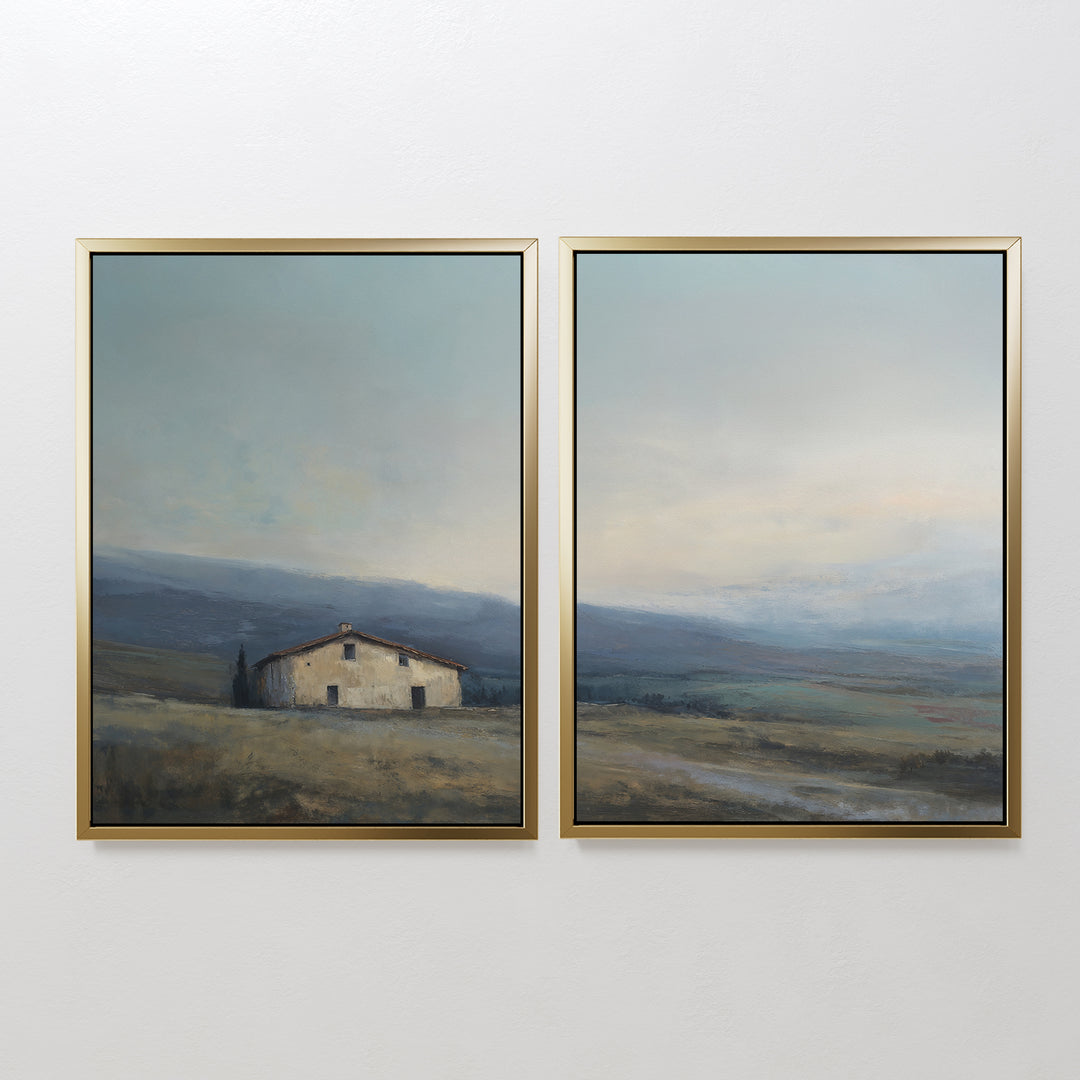 The Rustic Solitude - Set of 2 features framed wall art: one print shows a farmhouse in an open field, the other depicts tranquil mountains under a soft, muted sky—perfect for adding serene landscape decor to any room.