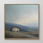 The Rustic Solitude Canvas Art - Square features a small house on a grassy hillside beneath a cloudy sky with distant blue-gray mountains, creating tranquil landscape decor for any space.