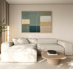 Minimalist living room with a light beige sectional sofa, a low wooden coffee table with books and a bowl, floor-to-ceiling curtains, a tall plant in the corner, and modern Sage Compartments Canvas Art - Horizontal on the wall.