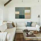 A bright living room with white shiplap walls, a cream sectional sofa with assorted pillows, a rustic wooden coffee table, and the Sage Compartments Canvas Art - Horizontal above the couch for a modern decor touch.
