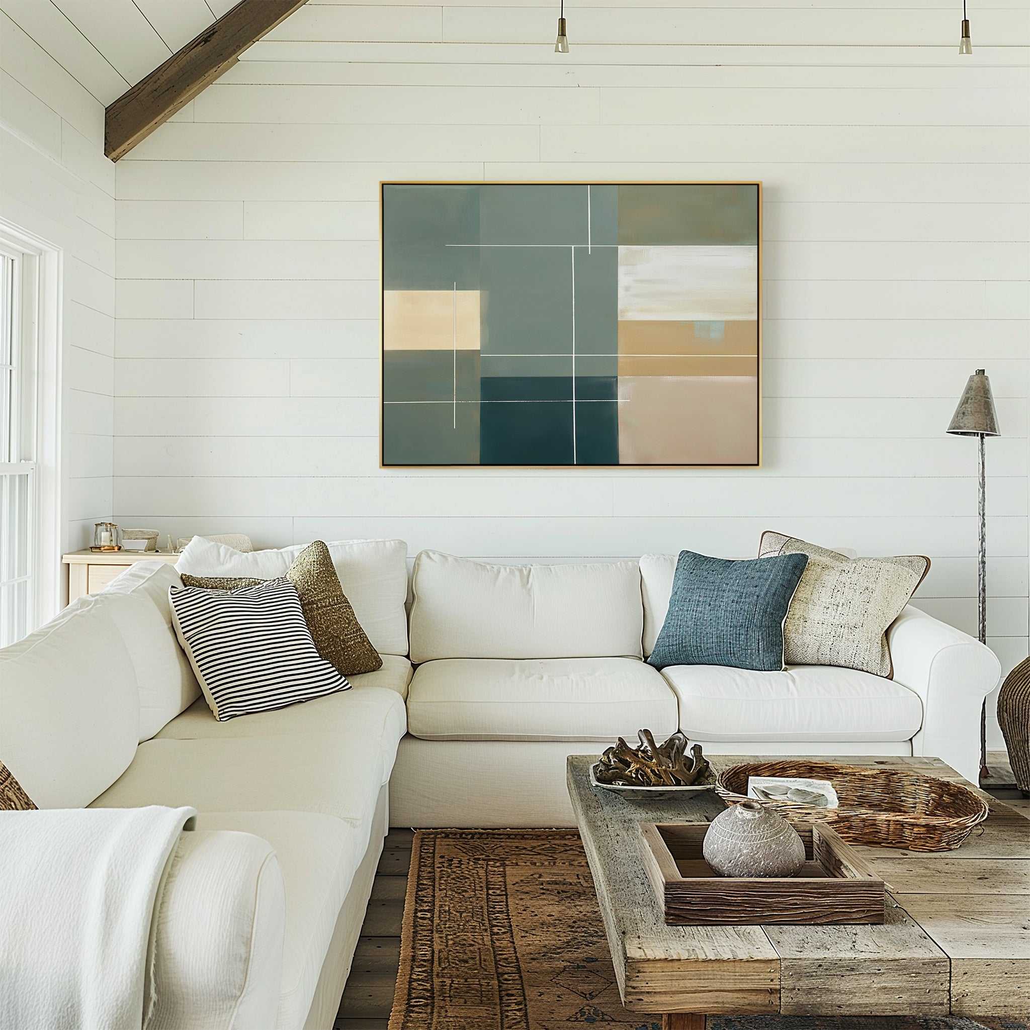 A bright living room with white shiplap walls, a cream sectional sofa with assorted pillows, a rustic wooden coffee table, and the Sage Compartments Canvas Art - Horizontal above the couch for a modern decor touch.