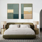 A modern bedroom features an olive green bed, white bedding, two Sage Compartments - Set Of 2 as nightstands with beige lamps, a textured area rug, and two pieces of modern wall art above the bed on a white wall.