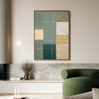 Minimalist living room featuring the Sage Compartments Canvas Art - Vertical in green, beige, and yellow tones above a marble shelf, with a round green sofa, dried flowers in a vase, and a compact wall light.
