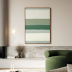 A modern living room with a green curved sofa, the Sage Gradient Canvas Art - Vertical featuring soothing abstract stripes, a minimalist wall light, a vase with dried branches, and neutral-toned decor.