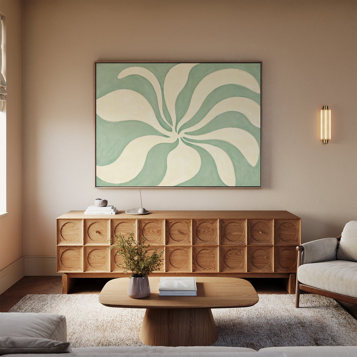 A modern living room features a wooden coffee table, textured wooden sideboard, light sofa, and Sage Meditation Canvas Art - Horizontal above. A lamp, books, and plant sit on the sideboard as warm lighting completes the Nordic Park-inspired space.
