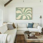 A bright living room with white shiplap walls, a large white sectional, neutral and blue pillows, a rustic wood coffee table, and the Sage Meditation Canvas Art - Horizontal above the sofa adds a Nordic Park-inspired touch.