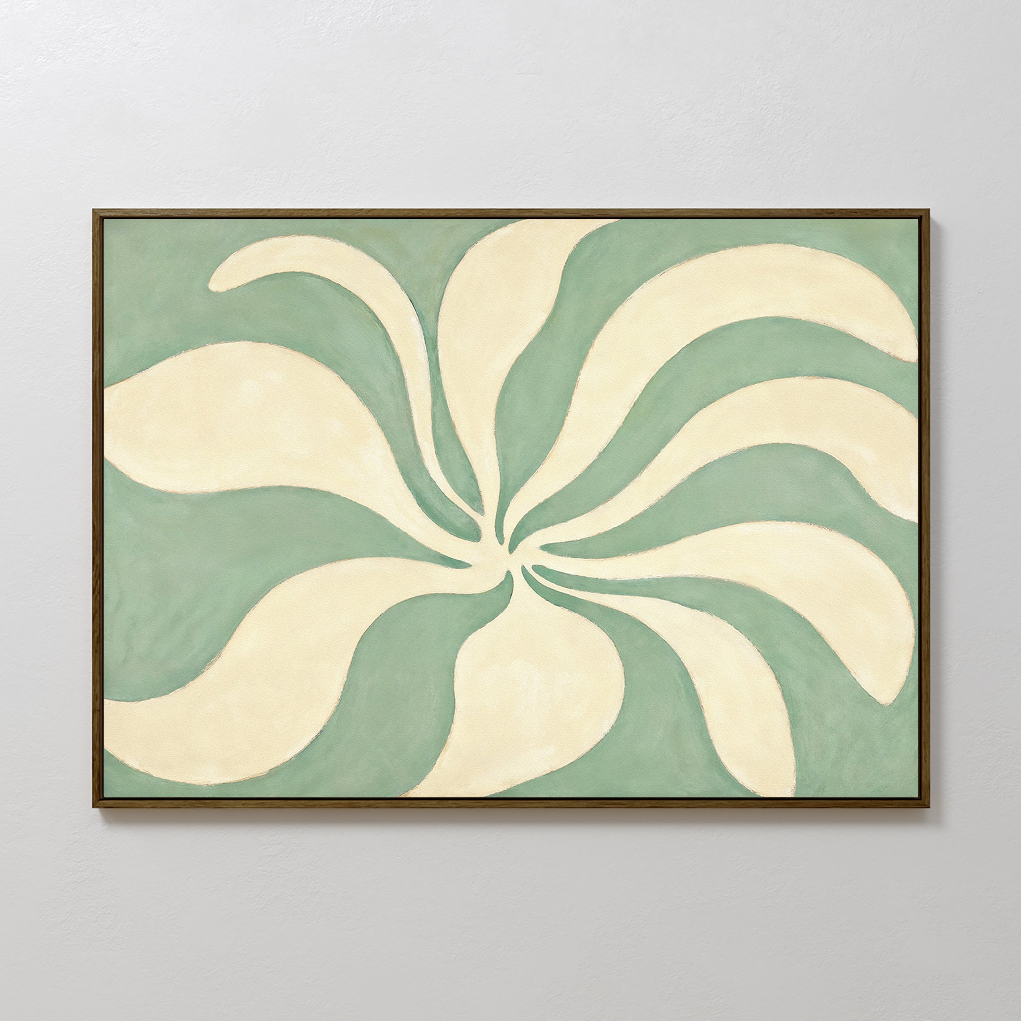 The Sage Meditation Canvas Art - Horizontal features cream-colored, curved shapes radiating from the center on a muted green background, framed in a thin dark border and displayed as calming sage green wall art against a light gray wall.