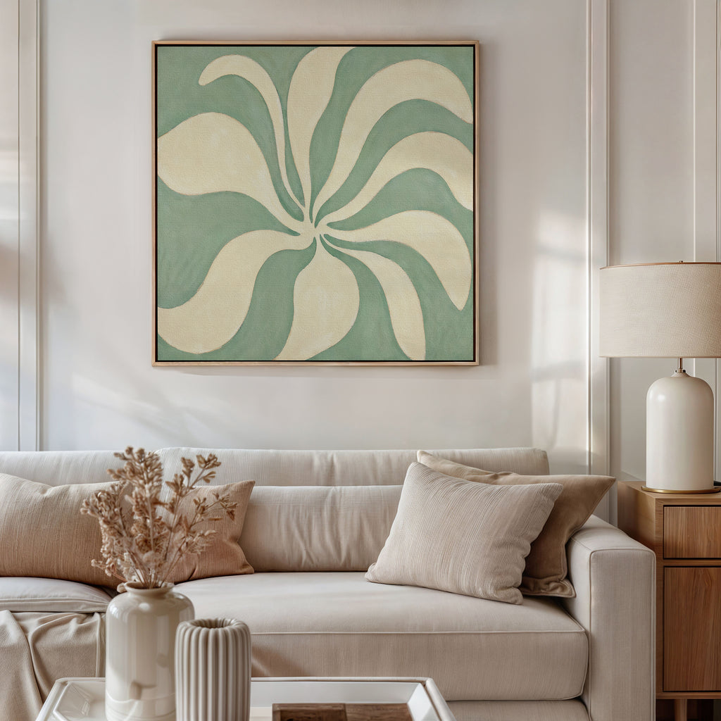 A neutral-toned living room features a white sofa, beige cushions, and a wooden side table with a lamp. Above the sofa hangs the Sage Meditation Canvas Art - Square, bringing calm Nordic Park-inspired style to this serene space.
