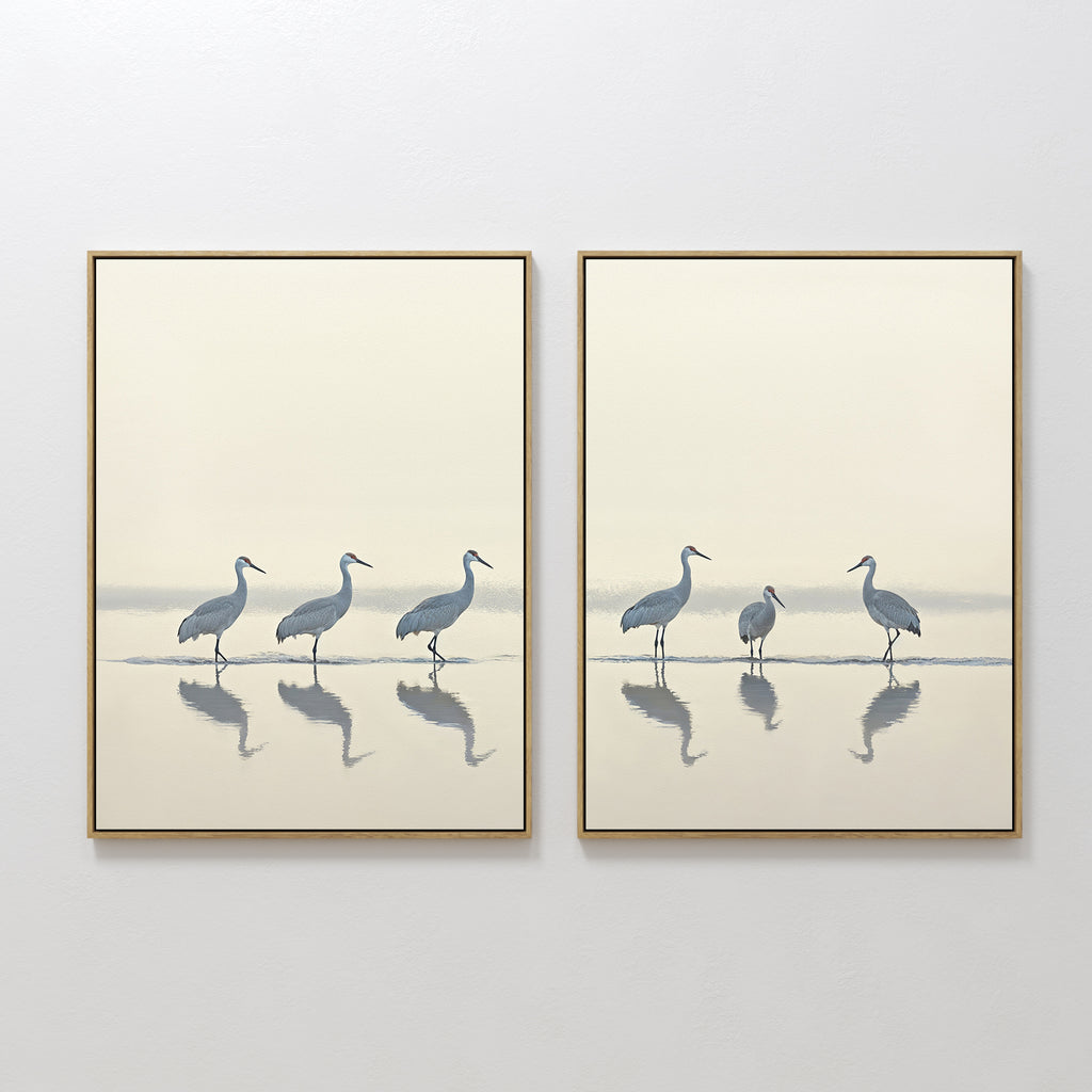 The Sandhill Procession - Set Of 2 features minimalist wall art prints of herons in soft neutral tones. Displayed side by side, these calming artworks bring serene decor to any white wall.