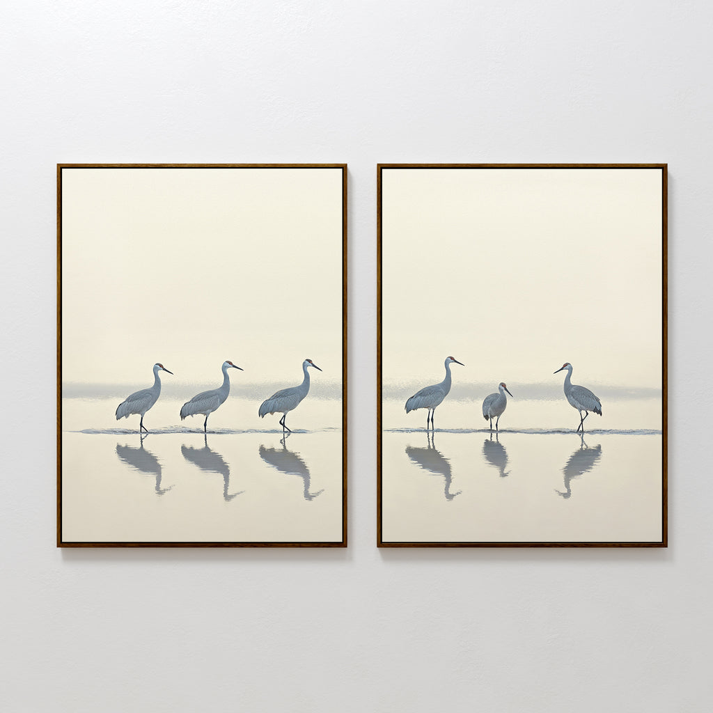 The Sandhill Procession - Set Of 2 features framed prints of heron silhouettes in shallow water with reflections and a soft gradient background, creating calm, minimalist wall art—ideal for serene home decor.