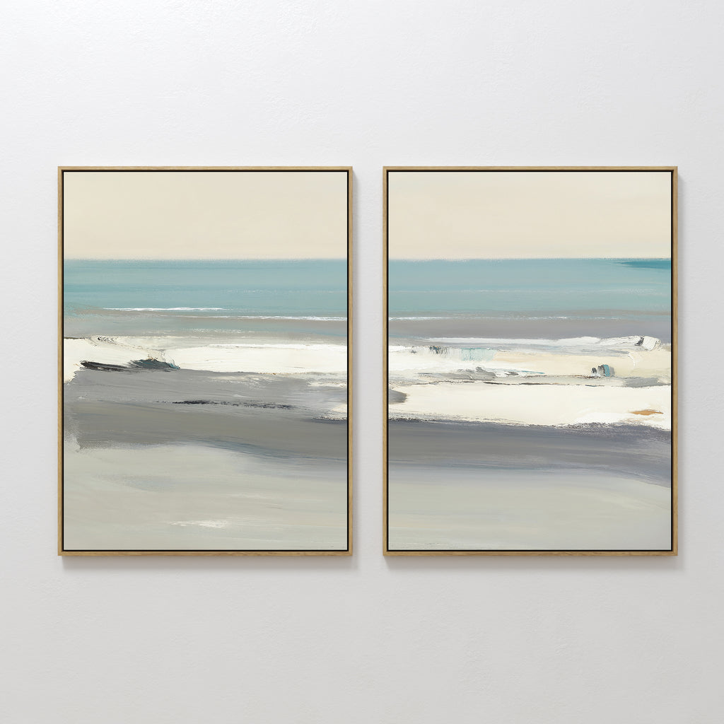 The Sandy Retreat - Set Of 2 features framed abstract paintings in soft blue, gray, and beige tones, displayed side by side on a white wall to evoke a tranquil seaside vibe with hints of ocean, sky, and shoreline.