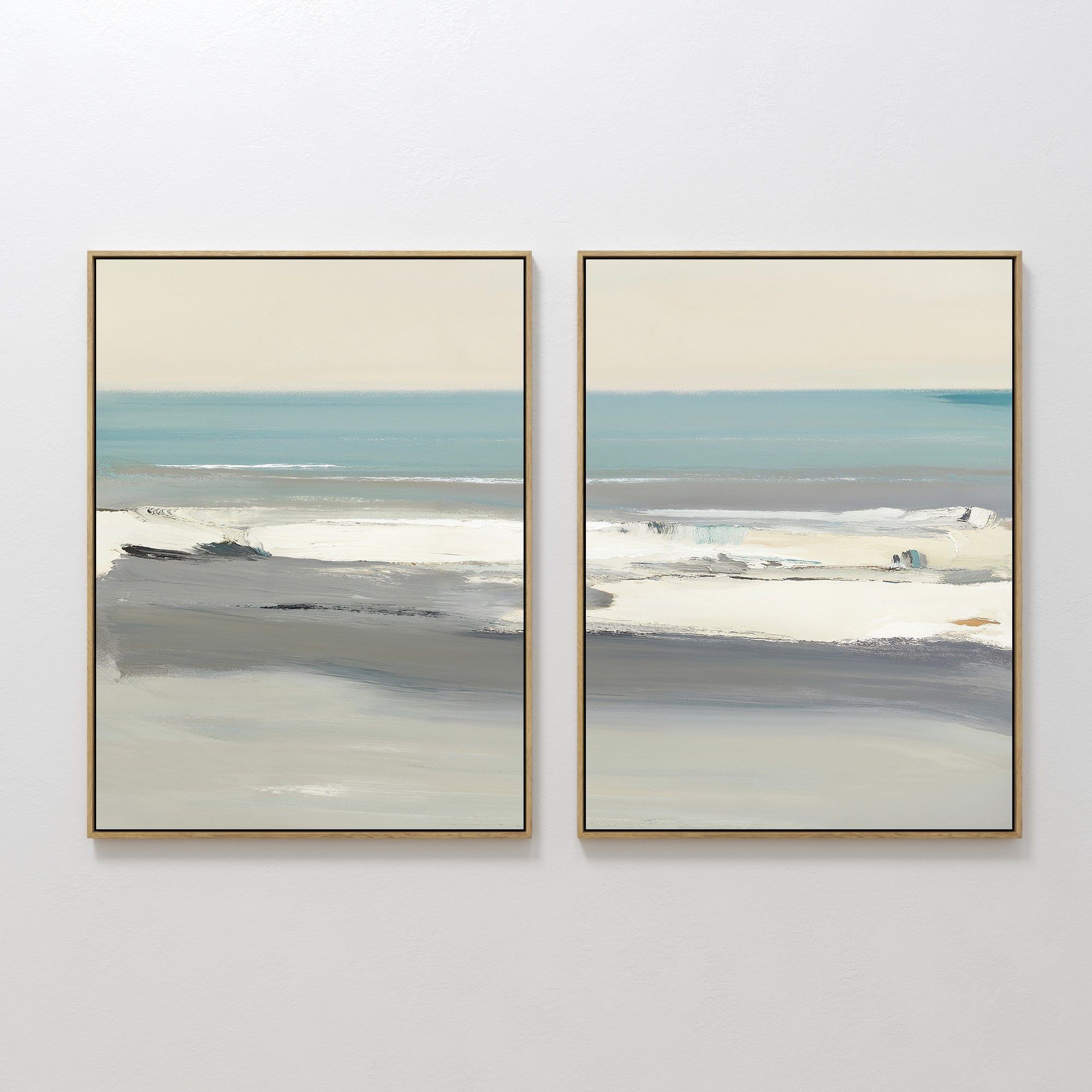 The Sandy Retreat - Set Of 2 features framed abstract paintings in soft blue, gray, and beige tones, displayed side by side on a white wall to evoke a tranquil seaside vibe with hints of ocean, sky, and shoreline.