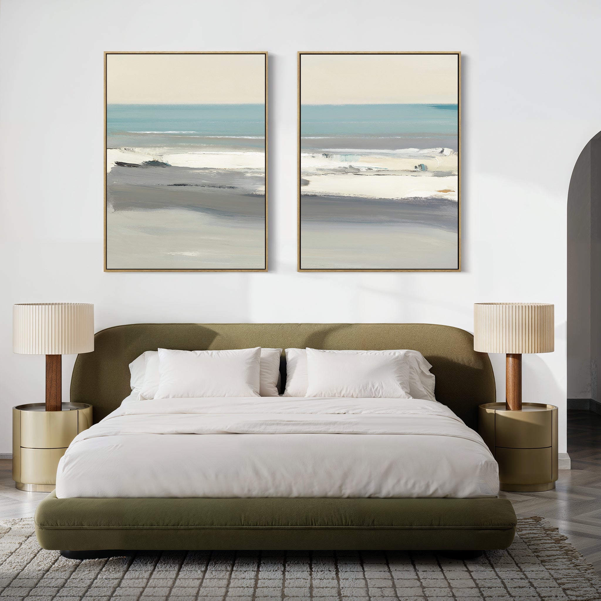 A modern bedroom with a green upholstered bed, white bedding, and two Sandy Retreat - Set Of 2 beige nightstands with matching lamps. Abstract coastal artwork above the bed complements the neutral palette, seaside vibes, and cozy rug.