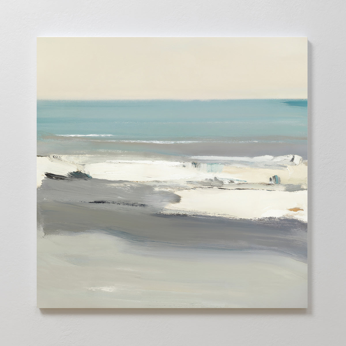 The Sandy Retreat Canvas Art - Square features an abstract seascape in soft blue, gray, white, and beige tones, with broad, blended brushstrokes evoking waves, shoreline, and sky for a tranquil coastal feel.