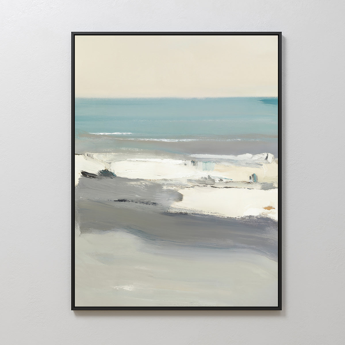 The Sandy Retreat Canvas Art - Vertical features an abstract seascape with soft blues, grays, and whites, depicting waves and sky. This coastal print comes in a simple black frame and is displayed against a white wall.